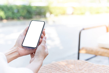Mockup image blank white screen cell phone.woman hand holding texting using mobile on desk at coffee shop.background empty space for advertise text.people contact marketing business,technology