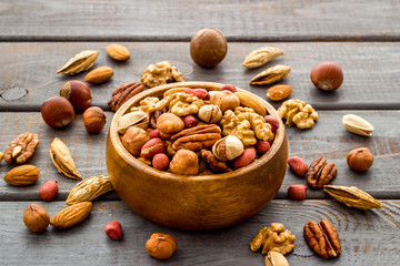 Mixed nuts in bowl - healthy snack - on wooden background