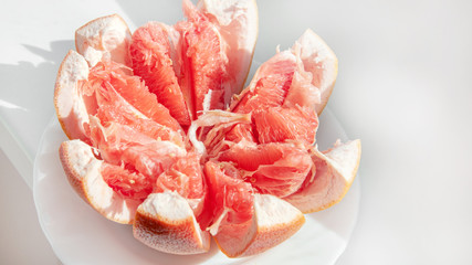 Red juicy ripe Israeli grapefruit in the cut. Fruit background. Copy of the space. Close up