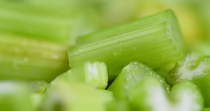 Pieces of celery falling water drops