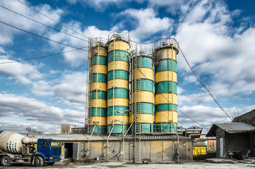 Concrete mixing plant. Four vertical towers for storing cement