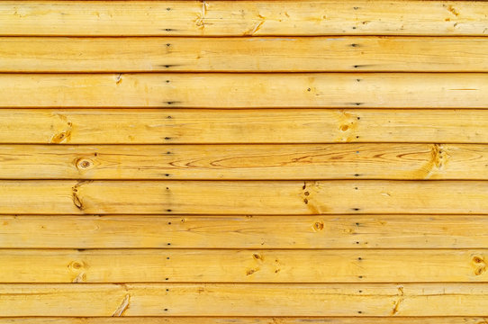 Untreated wood, wooden lattice fence or wall with nails. Close up. Background