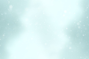 blurred snow / winter abstract background, snowflakes on abstract blurred glowing leaf background