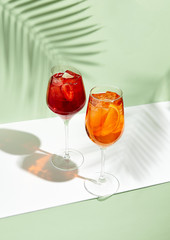 Red and orange summer cocktail on creative background