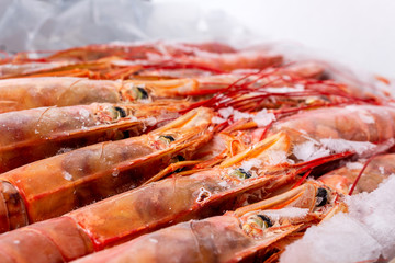 Amazing fresh large frozen shrimps. Pink fresh uncooked shrimps. Close-up. Delivery of frozen...