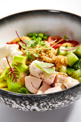Couscous with chiken and avocado closeup view