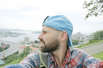 Vladivostok man bridge portrait, a man in a tourist cap in Russia