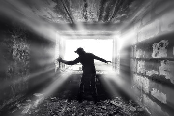 man against the background of a window in a ruined house, horror, fear concept, radiation stalker...