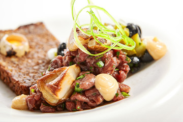 Beef tartare with greenery closeup view