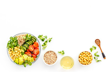 Vegan Buddha bowl. Avocado, quinoa, tomato, spinach and chickpeas vegetables salad on white table top-down copy space © 9dreamstudio