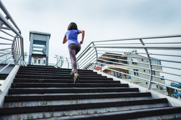 A woman runs up the stairs.