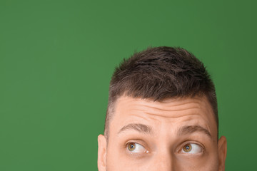 Thoughtful man on color background. Concept of choice