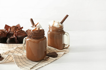 Mason jars of hot chocolate on table