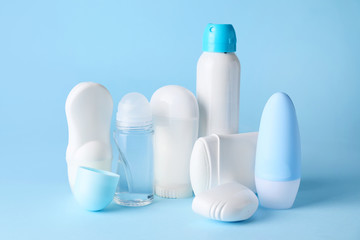 Different deodorants on color background