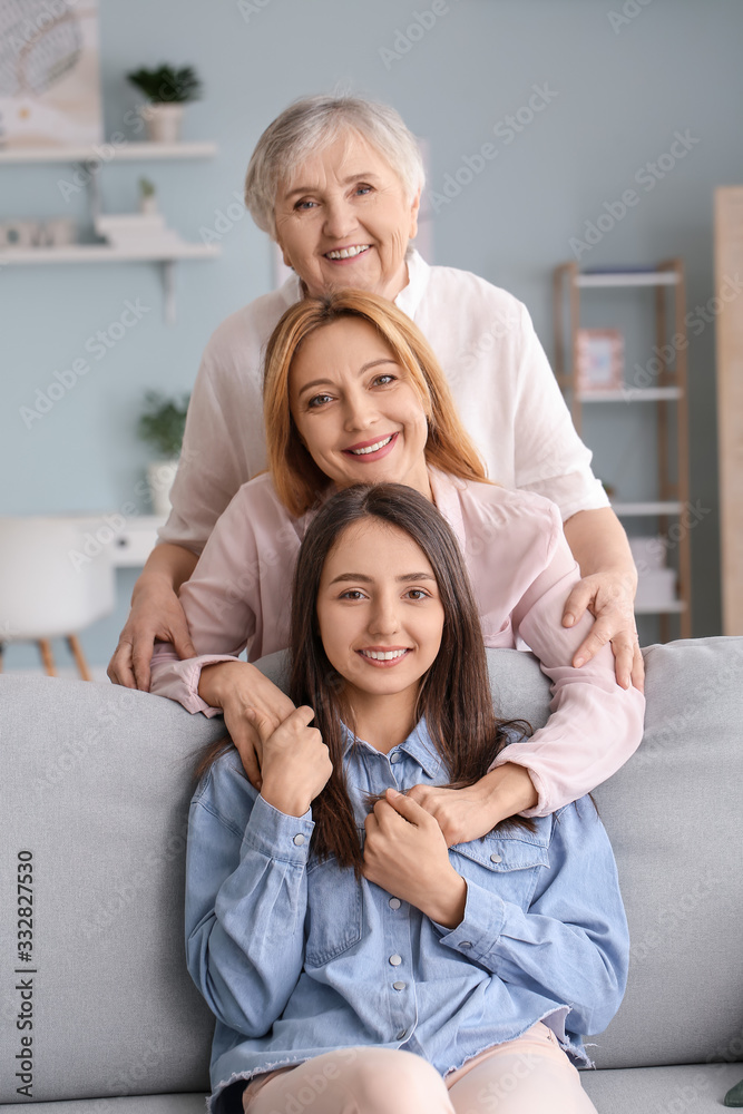 Canvas Prints Mature woman with her adult daughter and mother spending time together at home