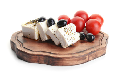 Board with tasty feta cheese, olives and tomatoes on white background