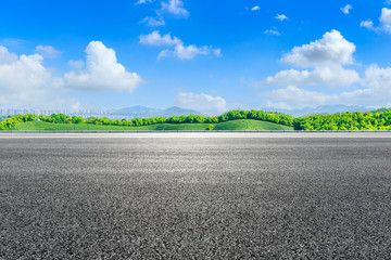 Asphalt road and green tea mountain nature landscape on sunny day.