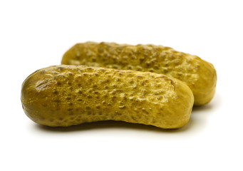 Marinated pickled cucumbers on white background