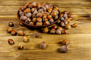 Hazelnuts in ceramic plate on a wooden table