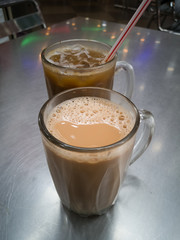 Teh tarik or pulled tea is a famous sweet milk tea in Malaysia. Bubble is floating on the surface of teh tarik.