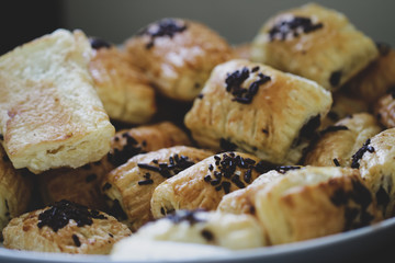 close up of puff pastry on the dish. topping up with chocolate sprinkles