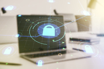 Double exposure of creative lock hologram with chip on laptop background. Information security concept