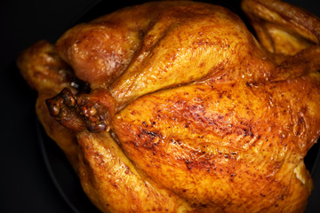 Roasted chicken in baking dish. Top view. Copy space. Macro shoot, selective focus
