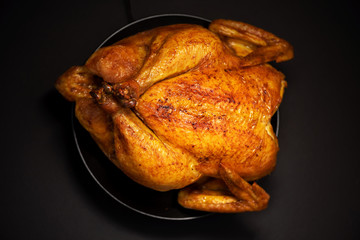Roasted chicken in baking dish. Top view. Copy space. Macro shoot, selective focus