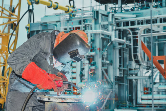 Welder is welding Industrial worker at factory welding close up, welding process by mig ( metal inert gas )swan neck.