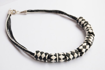 Black white geometric necklace. Handmade jewelry background.