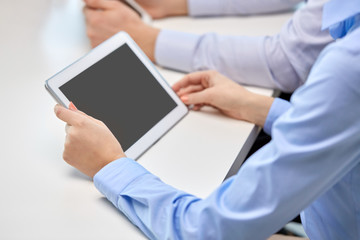 people and technology concept - close up of businesswoman with tablet pc computer at office