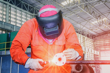 Industrial Worker tig welding process at the factory welding close up.