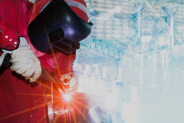 welder is welding in Industrial business concept with technician focus on welding process with...