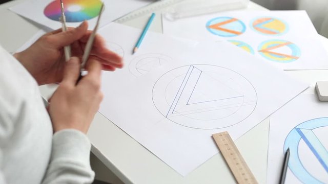 Graphic designer draws a sketch of a brand logo.