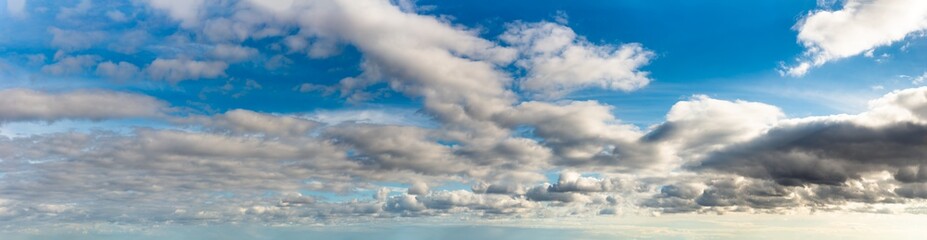 Fantastic clouds against blue sky, panorama