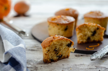 Delicious muffin with orange on a wooden table.