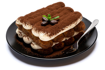 Classic tiramisu dessert on ceramic plate isolated on white background with clipping path