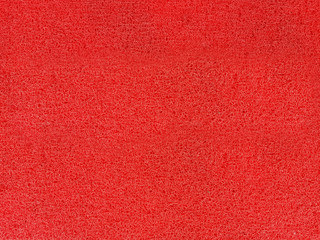the red background from synthetic fiber carpet