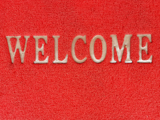 the synthetic fiber carpet with white leters "WELCOME"