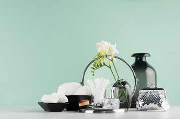 Cosmetic accessories for face skin care and make up in elegant green mint menthe bathroom interior...