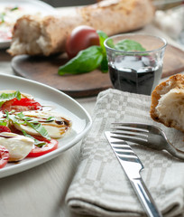 caprese, italian antipasto on a wooden table