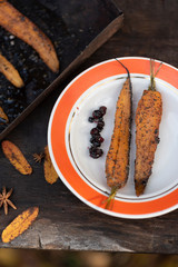 baked carrots in the autumn in the fresh air. Served on a plate.