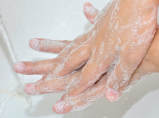 Fototapeta premium Corona virus pandemic prevention wash hands with soap.Personal hygiene concept.