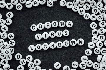 Words CORONA VIRUS LOCKDOWN made from small white letters on black background