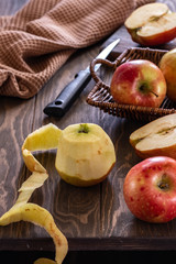 Fresh and juicy red apples in a basket on a wooden table