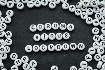 Words CORONA VIRUS LOCKDOWN made from small white letters on black background