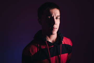 Young Man in a Jumper Dancing Contemporary Dance in Studio. Breakdancing. Dance School Poster. Copy Space. Battle competition announcement. Pink and Blue Background.