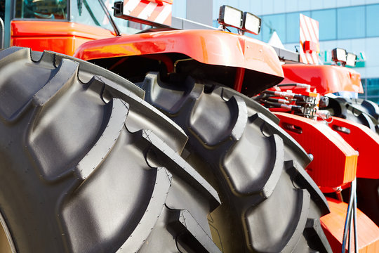 Closeup of big black rubber wheels of an agricultural tractor