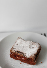 piece of chocolate cake with icing sugar