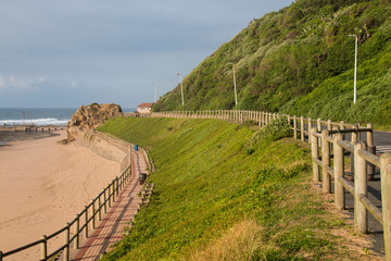 Fototapeta na wymiar Wood Fences Separate the Sand and Road at Beach